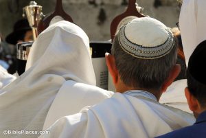 Two men praying in Jerusalem cover their heads, one with a prayer shawl and the other with a kippah. Photograph by Todd Bolen. Photo © BiblePlaces.com